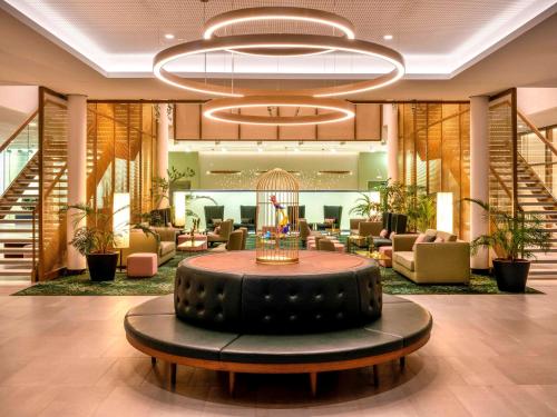 a lobby with a large tire sitting in the middle of a building at Mövenpick Hotel Stuttgart Messe & Congress in Stuttgart