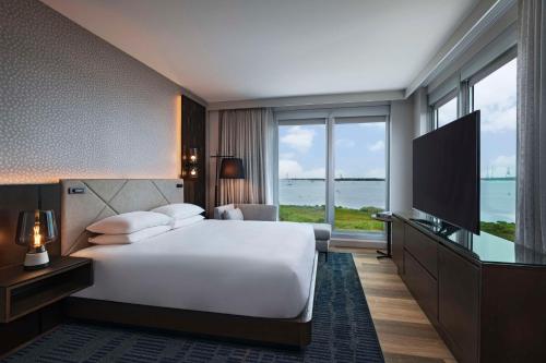a hotel room with a bed and a television at Hyatt Regency Baytown-Houston in Baytown