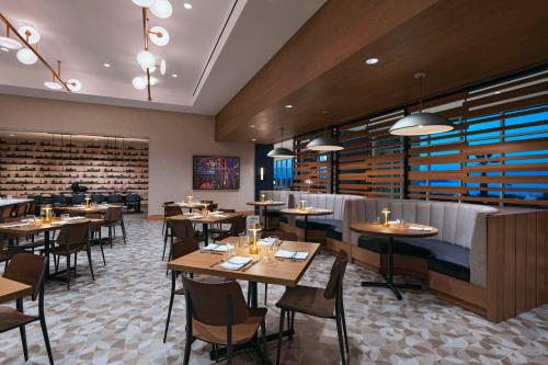 a restaurant with tables and chairs in a room at Hyatt Regency Baytown-Houston in Baytown