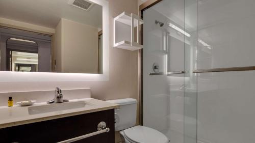 a bathroom with a toilet and a sink and a shower at The Hub Murray Hill, BW Premier Collection in New Providence