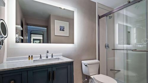 a bathroom with a toilet and a sink and a shower at The Westfield Inn, BW Signature Collection in Westfield
