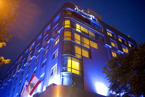 a hotel building with a sign on top of it at Radisson Blu Martinez Beirut in Beirut