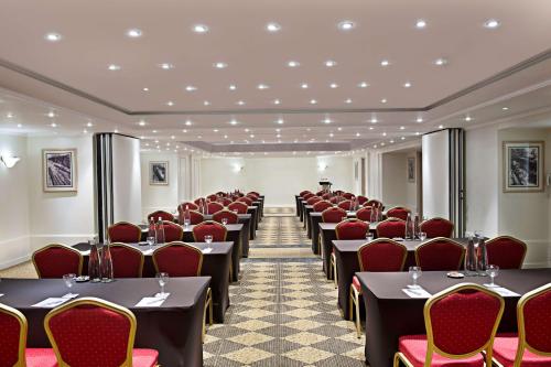 a row of tables and chairs in a room at Radisson Blu Martinez Beirut in Beirut