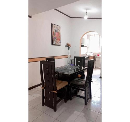a dining room with a table and chairs at Casa Celeste in Morelia