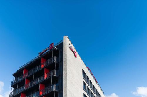 a building with a sign on the top of it at Radisson RED Hotel V&A Waterfront Cape Town in Cape Town