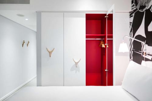 a room with a red door and a red wall at Radisson RED Hotel V&A Waterfront Cape Town in Cape Town