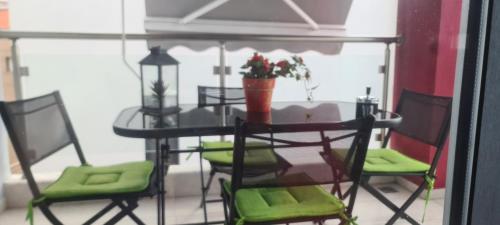 a table with chairs and a table with a potted plant at Perfect Suites in Neos Marmaras