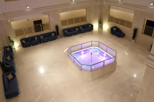 an overhead view of a large room with a pool and couches at شقق بيت المدينة للشقق المخدومة in Al Madinah