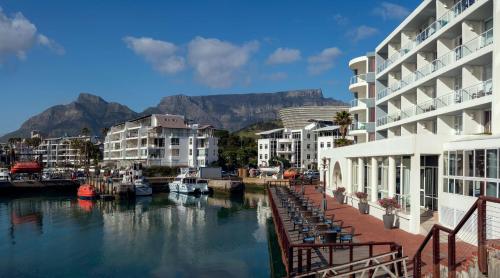a marina with buildings and a river with boats at Radisson Blu Hotel Waterfront, Cape Town in Cape Town
