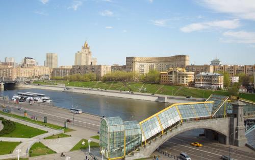 a bridge over a river in a city with buildings at Radisson Slavyanskaya Hotel & Business Center in Moscow