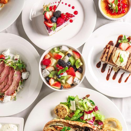 a group of plates of food on a table at Golden Tulip Muscat in Muscat