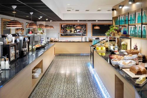 a restaurant with a counter with food on it at Park Inn by Radisson Central Tallinn in Tallinn