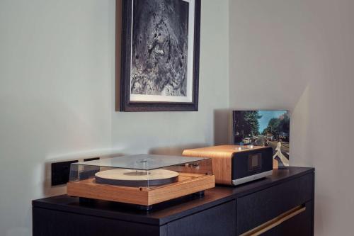 a desk with a tv on top of it at Holmes Hotel London in London