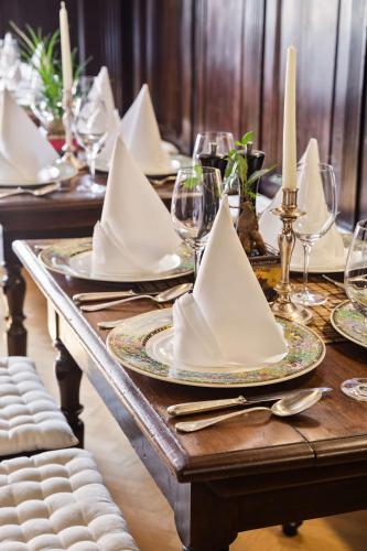 a wooden table with plates and napkins on it at Radisson Blu Hotel Altstadt in Salzburg
