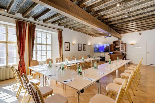 a large room with a long table and chairs at Radisson Blu Hotel Altstadt in Salzburg