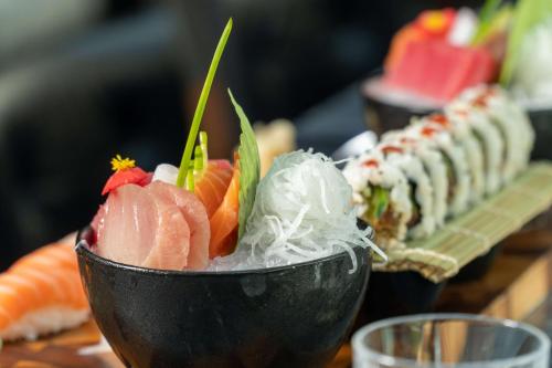 a bowl filled with sushi on top of a table at Radisson Blu Hotel Bucharest in Bucharest