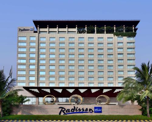 a tall building with a sign in front of it at Radisson Blu Hotel, Indore in Indore
