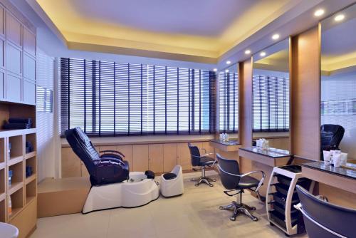 a hair salon with chairs and a barber shop at Radisson Blu Hotel, Indore in Indore