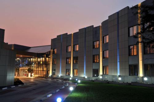 a building with lights in front of it at night at Radisson Blu Hotel Lusaka in Lusaka