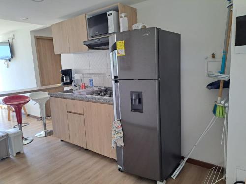a kitchen with a stainless steel refrigerator in a room at Lindo apartamento en Santa Marta, Rodadero, Gaira 503 in Santa Marta