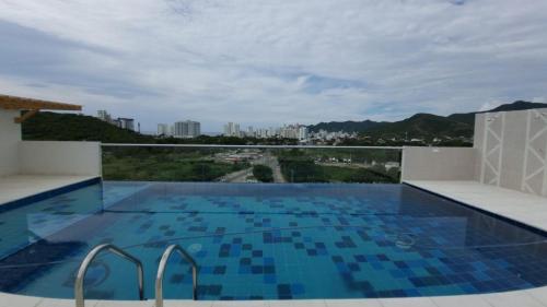 a swimming pool on the roof of a building at Lindo apartamento en Santa Marta, Rodadero, Gaira 503 in Santa Marta