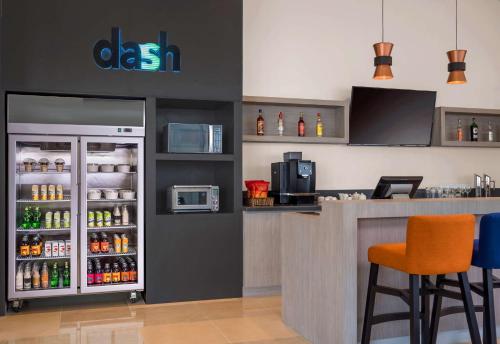 a bar with a refrigerator filled with lots of drinks at Park Inn By Radisson Iloilo in Iloilo City