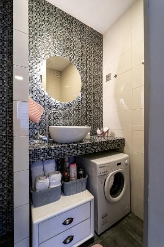 a bathroom with a sink and a washing machine at French House in Belgrade