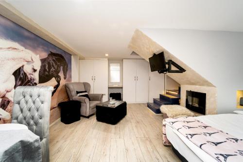 a room with a bed and a living room at French House in Belgrade