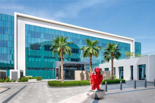 a red fire hydrant in front of a building at Radisson RED Dubai Silicon Oasis in Dubai
