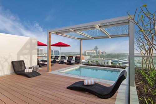 a deck with a swimming pool on a building at Radisson RED Dubai Silicon Oasis in Dubai