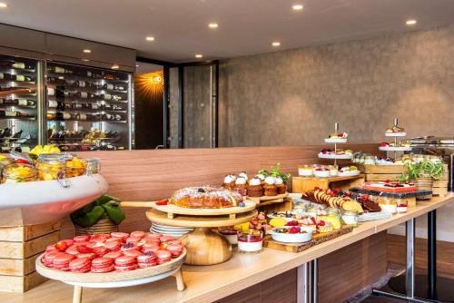 a buffet line with many different types of food at Radisson Blu Hotel, Rouen Centre in Rouen