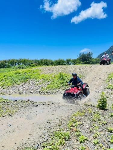 a man riding a quad bike on a dirt road at 東澳海安獨木舟旅人驛站 in Suao