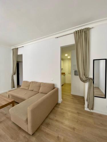 a living room with a brown couch in a room at Central Apartment BCN in Barcelona