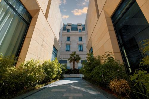 a walkway between two buildings in front of a building at Mansard Riyadh, a Radisson Collection Hotel in Riyadh