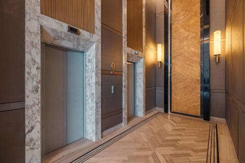 a hallway with a door in a building at Mansard Riyadh, a Radisson Collection Hotel in Riyadh