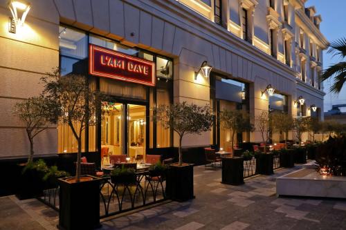 a restaurant with tables and chairs in front of a building at Mansard Riyadh, a Radisson Collection Hotel in Riyadh