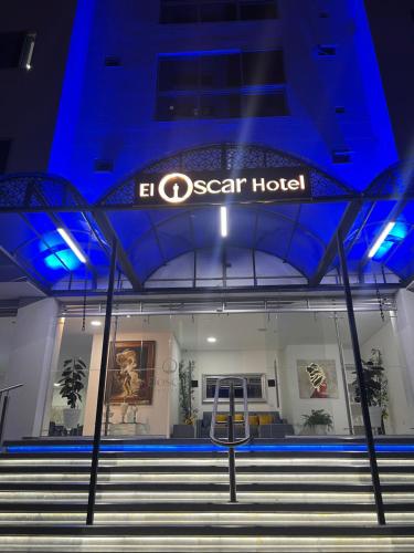 a sign on the front of a ocean hotel at night at El Oscar Hotel in Medellín
