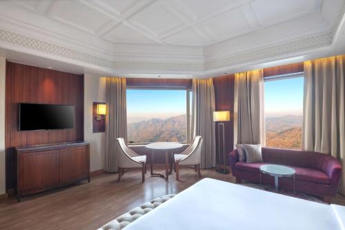 a room with a living room with a large window at Radisson Kufri in Shimla