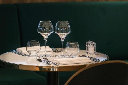 a table with four wine glasses and napkins at Radisson Blu Grand Hotel & Spa, Malo-Les-Bains in Dunkerque