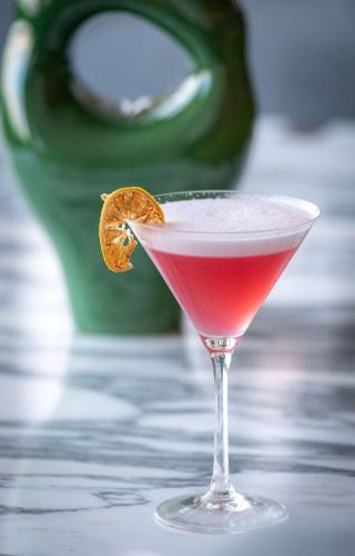 a red drink in a glass with an orange slice at Radisson Blu Grand Hotel & Spa, Malo-Les-Bains in Dunkerque