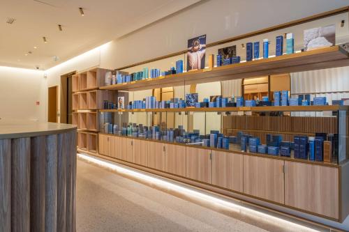 a library filled with lots of blue books on shelves at Radisson Blu Grand Hotel & Spa, Malo-Les-Bains in Dunkerque