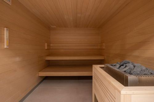 a sauna with wooden paneled walls and wooden shelves at Radisson Blu Grand Hotel & Spa, Malo-Les-Bains in Dunkerque