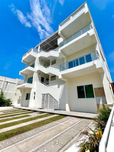 a white building with stairs in front of it at Casa Boutique Maria Bonita in La Manzanilla