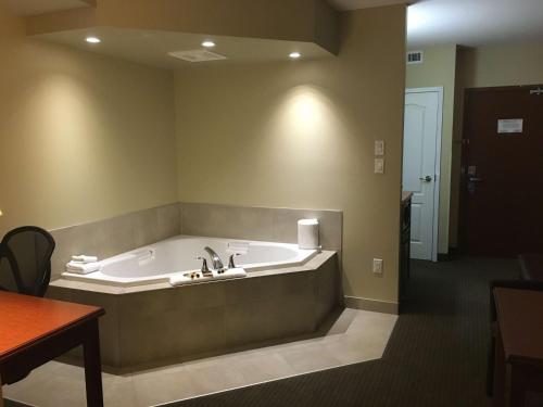 a large bath tub sitting in a room at Best Western Plus Service Inn & Suites in Lethbridge