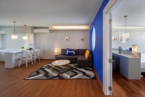 a living room with a couch and a table at Homm Bliss Southbeach Patong in Patong Beach