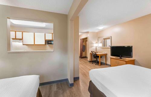 a hotel room with two beds and a flat screen tv at Extended Stay America Suites - Cleveland - Westlake in Westlake