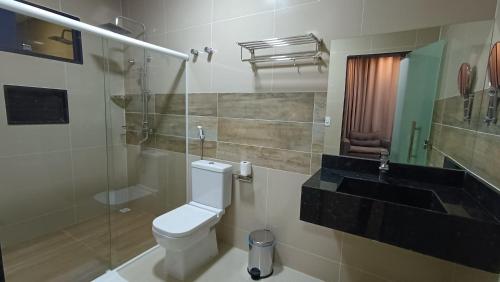 a bathroom with a toilet and a sink at Hotel Maxsuel 