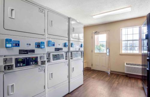 a laundry room with four washing machines and a window at Extended Stay America Suites - Charleston - North Charleston in Charleston