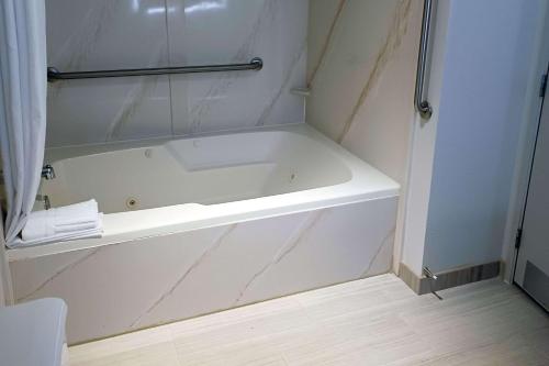 a white bath tub in a bathroom with a shower at Comfort Inn Edinburgh - Columbus in Edinburgh
