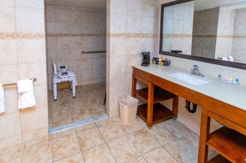 a bathroom with a sink and a shower with a mirror at Comfort Inn Downtown in Salt Lake City